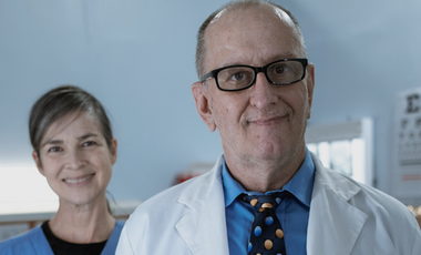Man in a lab coat with glasses